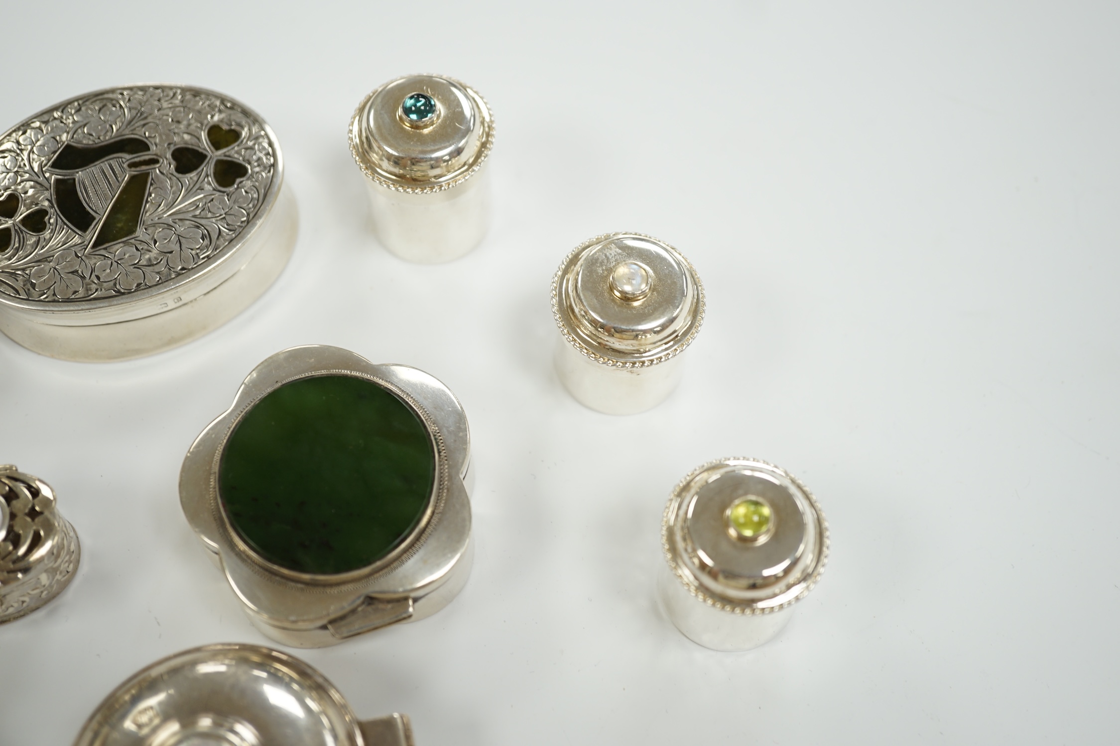 Nine assorted mainly modern silver or white metal and hardstone/cabochon set pill boxes, largest 59mm.